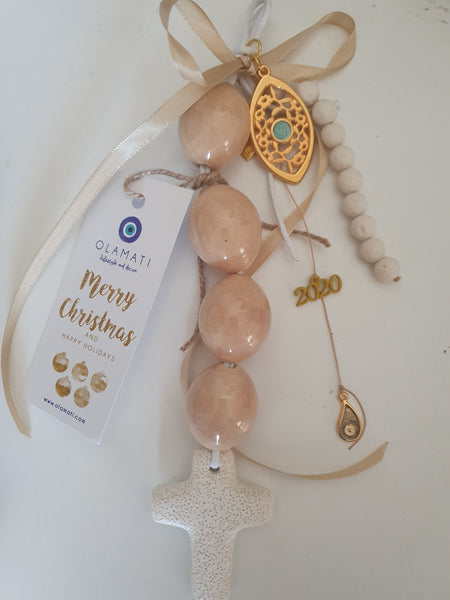 Light brown ceramic bead and mati with a cross wall hanging