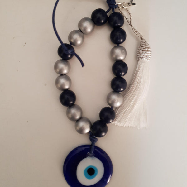 Silver and blue mati wall hanging with silver tassel and turquise cross