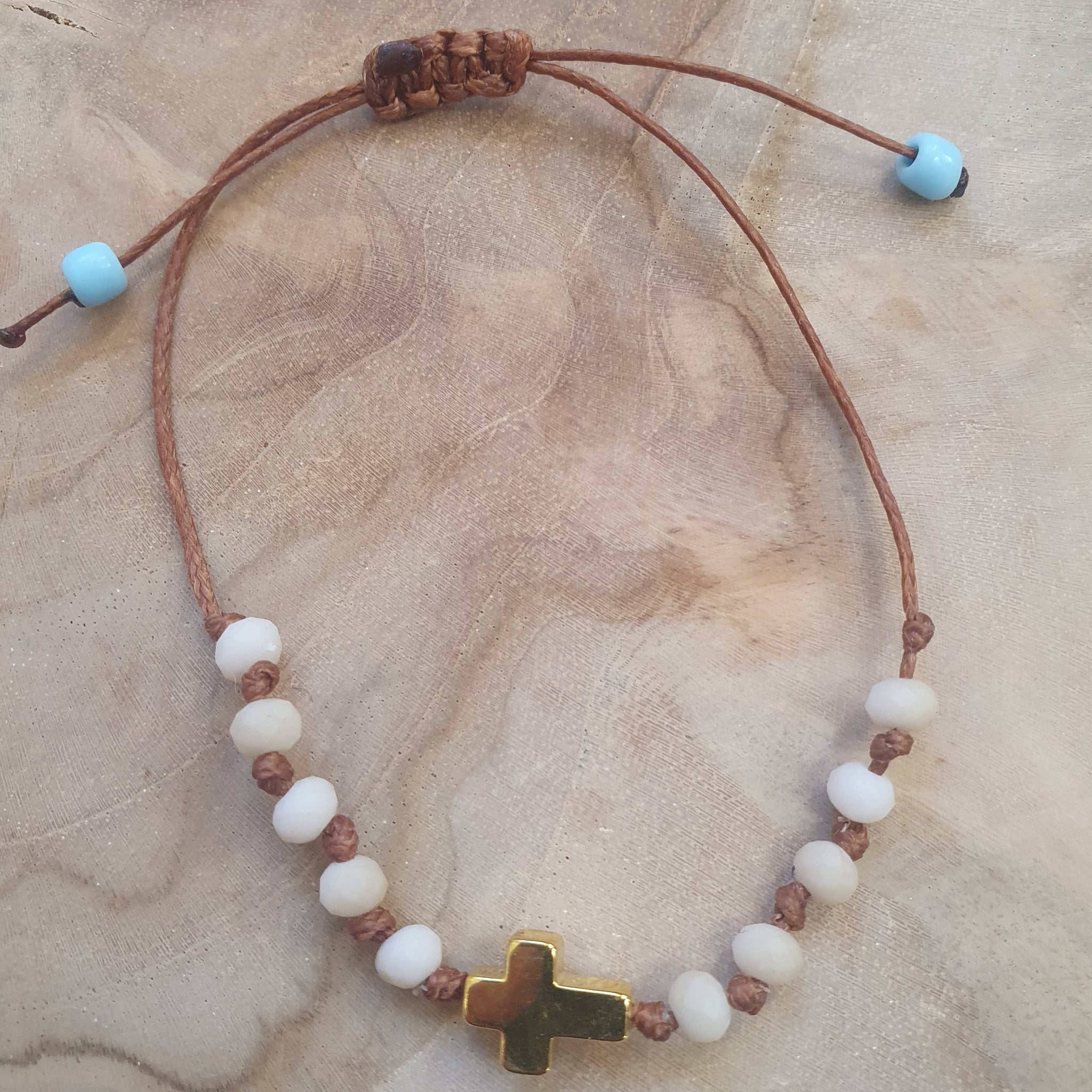 White_bead_and_cross_brcacelet