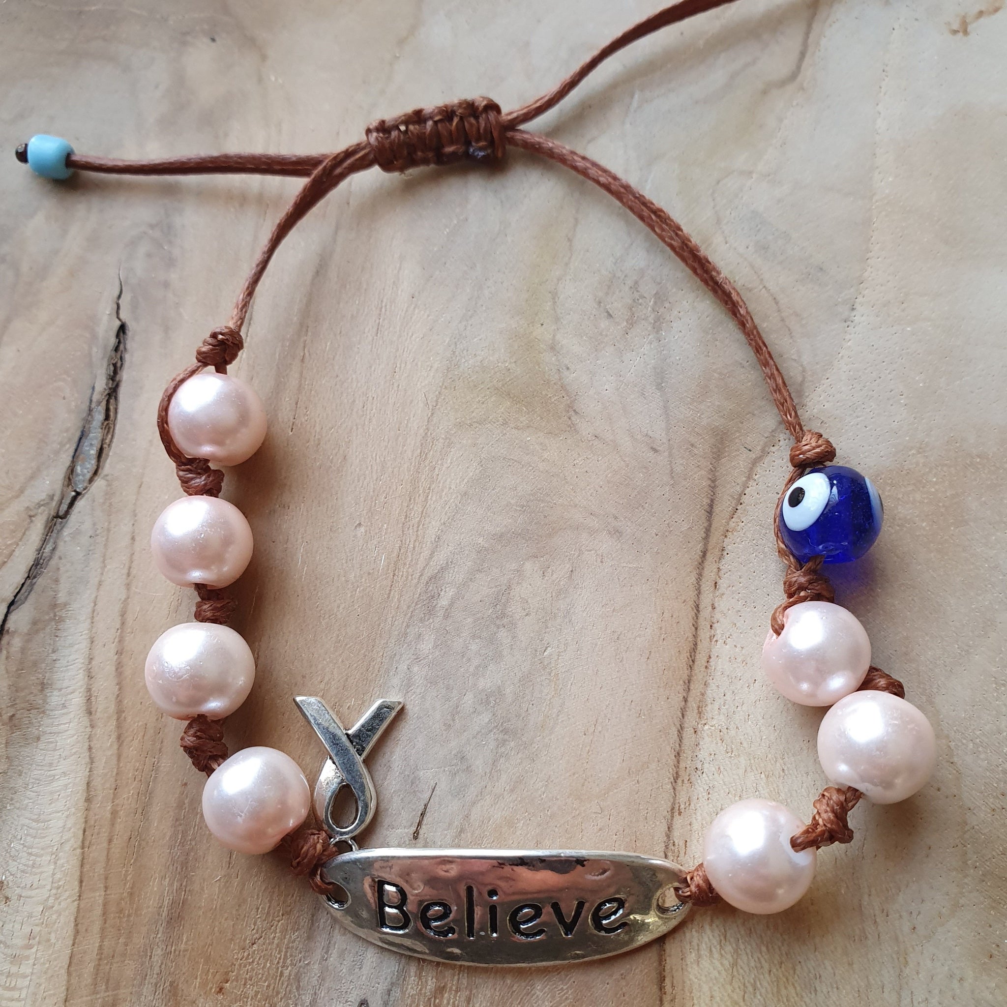 Ladies Believe bracelet with pearl beads and cancer ribbon