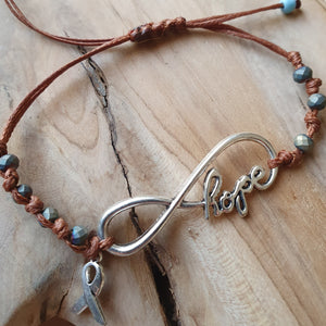 Hope bracelet with metallic silver stones and cancer ribbon