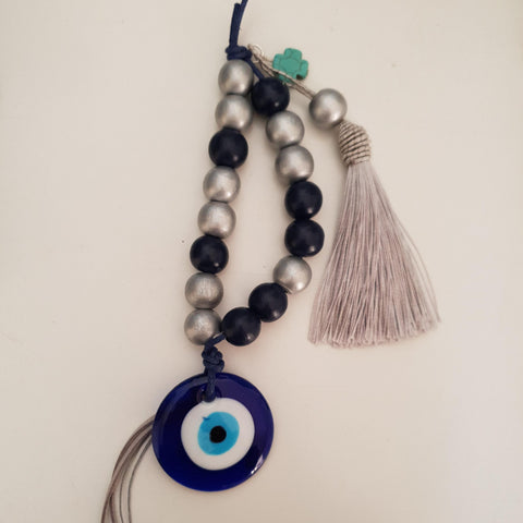 Silver and blue mati wall hanging with silver tassel and turquise cross